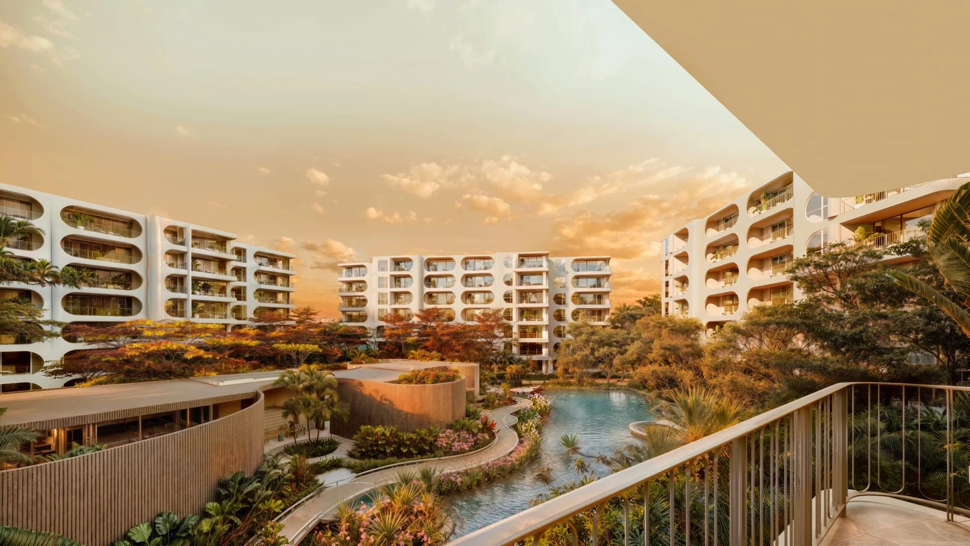 The Standard Residences Phuket Bang Tao seen over the gardens and pool at golden hour — project rendering